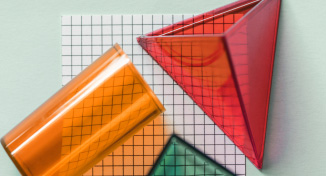 Imagem de Three plastic shapes on top of drawing paper